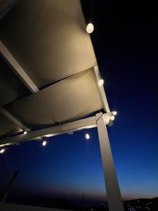 a group of lights under a bridge at night at White & Blue in Batsi