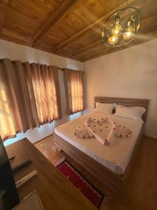 a bedroom with a bed and a chandelier at Hotel Borklad in Berat +37 photos