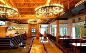 a large room with chandeliers and tables and chairs at Sun Moon Bed& Breakfast 日月民宿 in Wulai