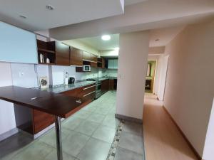 a large kitchen with a table in a room at Ushuaia Armonia in Ushuaia