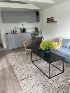 a living room with a couch and a table at Nybyggd stuga i Onsala - nära till havet in Onsala