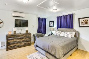 a bedroom with a bed and a flat screen tv at Walkable Paradise Downtown Puyallup Studio! in Puyallup