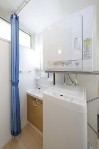 a small kitchen with a washer and a sink at Rana Enoshima - Vacation STAY 94777v in Fujisawa +25 photos