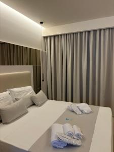 a hotel room with a bed with towels on it at Sunset Beach Club Tropea in Tropea