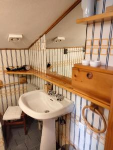 a bathroom with a sink and a mirror at VAL DI FASSA CENTRAL HOUSE - Rooms with free parking in Canazei