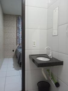 a bathroom with a sink in a room at Casa MD in Camocim
