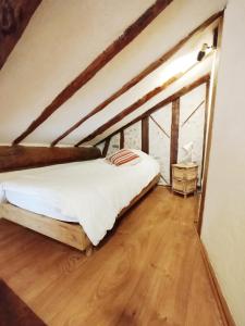 a bedroom with a bed in a attic at Maison de charme au cœur d'Ax-Les-Thermes in Ax-les-Thermes