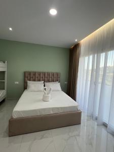 a bedroom with a large bed with white sheets at Break Room Dea in Draç