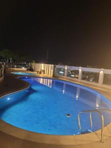 a large swimming pool on top of a building at night at Ap Royal Mirage in Florianópolis