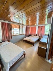 a bedroom with two beds and a wooden ceiling at FLOWER PANSıYON KEKOVA in Demre +24 photos