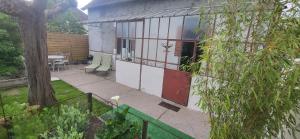 a building with a patio with a table and chairs at gîte avec sauna in Blois