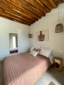 a bedroom with a large bed in a room at Kisari Kimolos Chorio Double Room in Kimolos