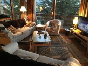 a living room with two couches and a tv at Family Cottage with a View in Mont-Louis