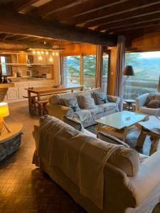 a large living room with couches and a table at Family Cottage with a View in Mont-Louis