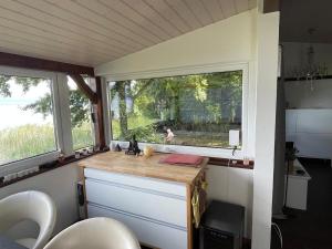 a kitchen in a tiny house with a window at Le Chalet in Font