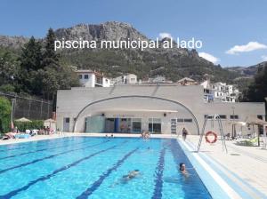 a pool at a hotel with people in the water at Almansasalud in Cazorla