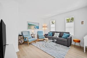 a living room with a couch and two chairs at Oystershell Cottage in Port Royal
