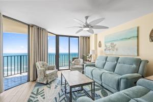 a living room with a couch and a table at The Summit #9E - Oceanfront in Myrtle Beach