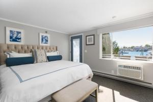 a bedroom with a large bed and a window at Boothbay Harbor Oceanside Inn in Boothbay Harbor