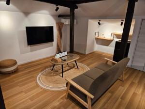 a living room with a couch and a table at PrivateVilla Isola - Vacation STAY 28837v 