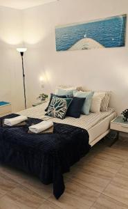 a bedroom with a large bed with pillows on it at Sunshine Beach Apartments in Adeje