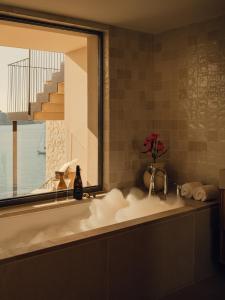 a bathroom with a sink and a window with a view at Aethos Mallorca in Paguera