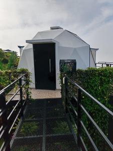 a building with a black door and a fence at Sunrise Hill Glamping in San Juan