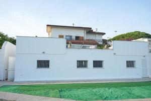 a white building with blue paint on it at Terracina Seaside Apartments in Lido Di Fondi