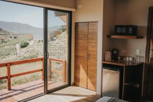 a kitchen with a sliding glass door with a view at Cabañas by 7 Valles in Valle de Guadalupe