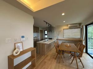 a kitchen and dining room with a table and chairs at LAGUNA OKINAWA Beachfront - Vacation STAY 30553v in Yaka +9 photos
