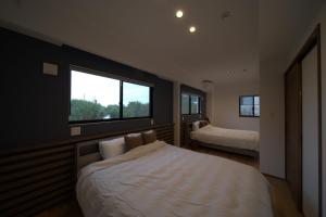 a bedroom with two beds and a window at LAGUNA OKINAWA Beachfront - Vacation STAY 30548v in Yaka