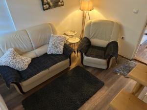 a living room with a couch and a chair at Vikendica Nadja in Divčibare