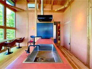 a kitchen with a sink in the middle of a room at Farm Stay Yululu - Vacation STAY 30762v in Sumoto