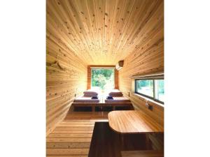 a room with four beds in a wooden room at Farm Stay Yululu - Vacation STAY 30762v in Sumoto
