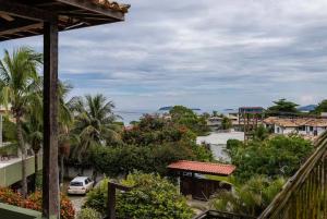 a view from a balcony of a town with a car at Vista Mar em Búzios Praia de Geribá c/ Piscina in Búzios