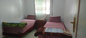 Postel nebo postele na pokoji v ubytování Dar Choubi
