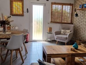 a living room with a table and a chair at Villa de Gracia Casa 3 in Tordera