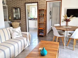a living room with a couch and a table at Villa de Gracia Casa 3 in Tordera