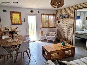 a living room with a table and a dining room at Villa de Gracia Casa 3 in Tordera +36 photos