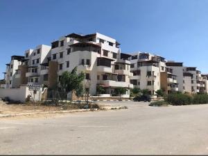 a large apartment building on the side of a road at Appartement dunes de Martil in Martil