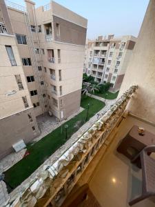 a view from the balcony of an apartment building at شقه في مدينتي غرفتين و صاله مكيفه مفروشه فندقي - Fully Furnished & Air-Conditioned 2-Bedroom Apartment with Large Living Room in Madinaty - 98 sqm in Madinaty