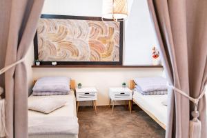 a room with two beds and a painting on the wall at Apartament 592 in Boguszów-Gorce