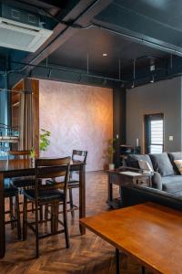 a living room with wooden tables and a couch at Duplex Ooba - Vacation STAY 33424v in Takahara