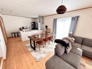a living room with a couch and a table at The Ritz Okinawa Kise II - Vacation STAY 36742v in Nago