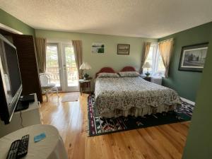 a bedroom with a bed and a television in it at Tudor House Bed and Breakfast in Bottrel