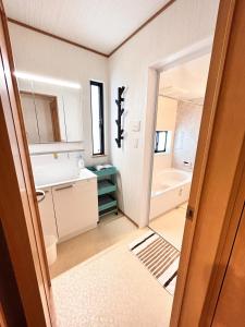 a bathroom with a sink and a bath tub at The Ritz Okinawa Kise II - Vacation STAY 36742v in Nago +42 photos