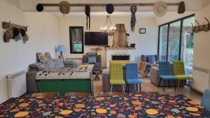 a living room with a table and chairs at Hotel Shindisi Inn Tbilisi in Tbilisi City