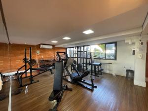 a gym with several treadmills and elliptical machines at Flat Crystal Place 209 in Goiânia