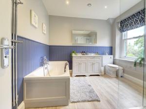 a bathroom with a tub and a sink and a toilet at The Farm House in Richmond +60 photos