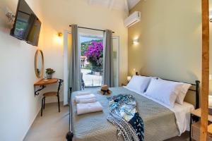 a bedroom with a bed and a sliding glass door at Sueño Central Apartments in Gaios